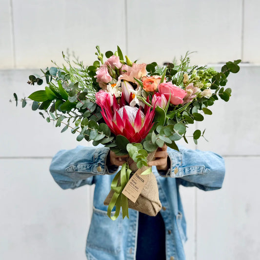 Person holding a bouquet of flowers with a white background