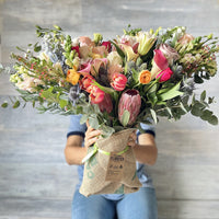 The biggest bouquet from Florster with 50 stems of tulips, roses, lilies, calas, protea and ranunculus.