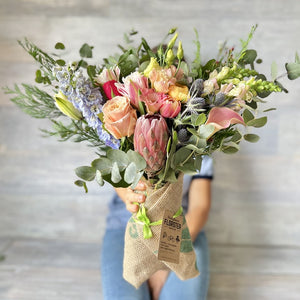 Bouquet of flowers with roses, protea, tulips from local growers of Catalonia. 
