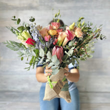 Load image into Gallery viewer, Just right bouquet made with 25 stems of flowers like proteas, roses, tulips and eucaliptus.